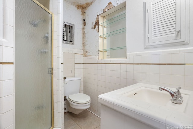 full bathroom featuring tile patterned flooring, tile walls, toilet, vanity, and a stall shower