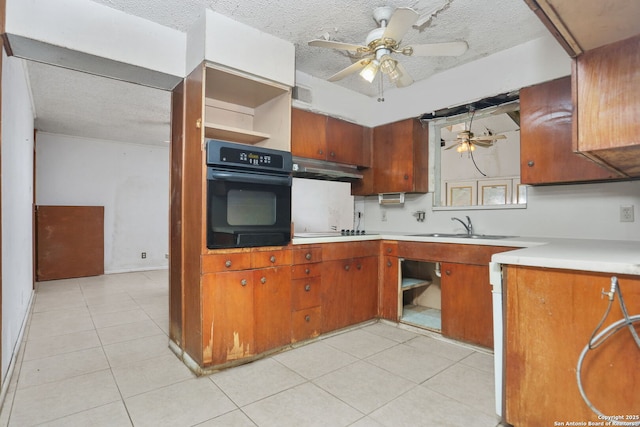 kitchen with black appliances, ceiling fan, a textured ceiling, and a sink