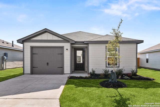 ranch-style house featuring a front lawn, concrete driveway, and an attached garage