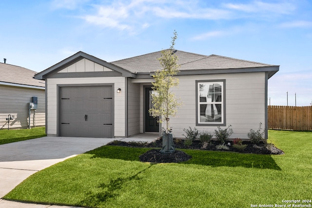 ranch-style house with fence, a front lawn, concrete driveway, and an attached garage