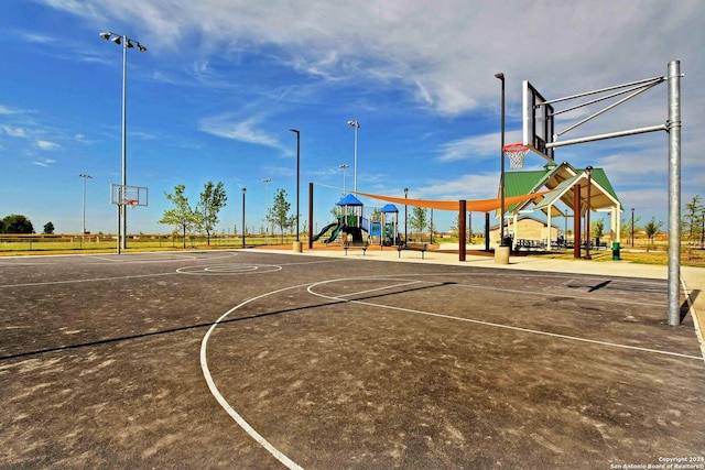 view of sport court featuring playground community and community basketball court