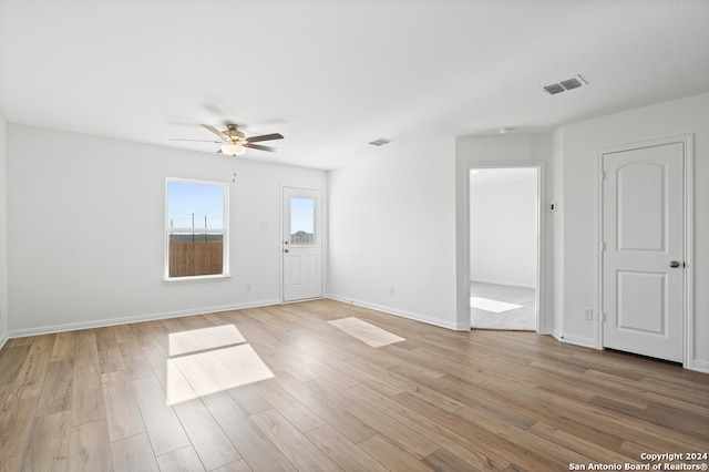 interior space featuring visible vents, ceiling fan, and light wood-style flooring