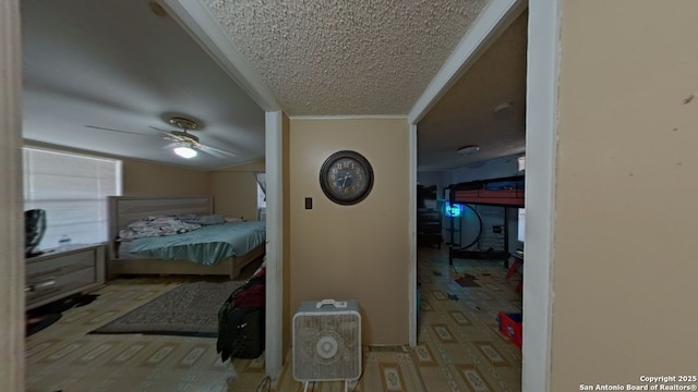 carpeted bedroom with a textured ceiling, ceiling fan, and crown molding