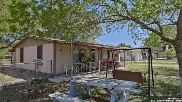view of front of property with a front lawn, a patio area, a gate, and fence