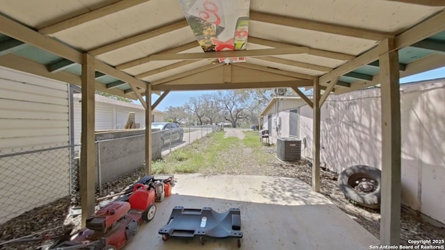 view of patio / terrace featuring fence and central AC unit