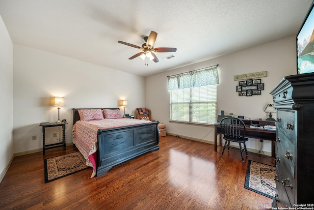 bedroom with baseboards, visible vents, and wood finished floors