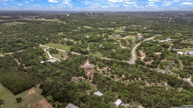 bird's eye view with a wooded view