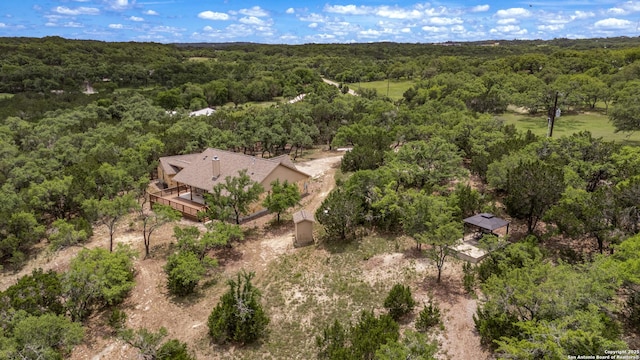 aerial view featuring a wooded view