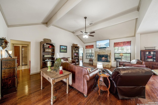 living room with vaulted ceiling with beams, a stone fireplace, a ceiling fan, and wood finished floors
