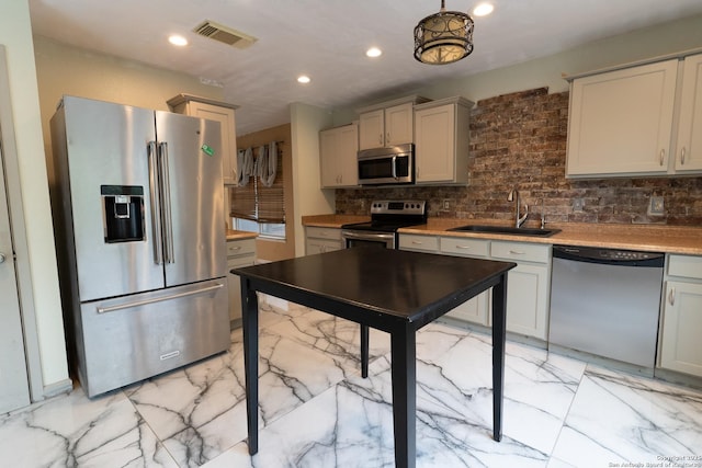 kitchen with tasteful backsplash, a sink, visible vents, stainless steel appliances, and marble finish floor