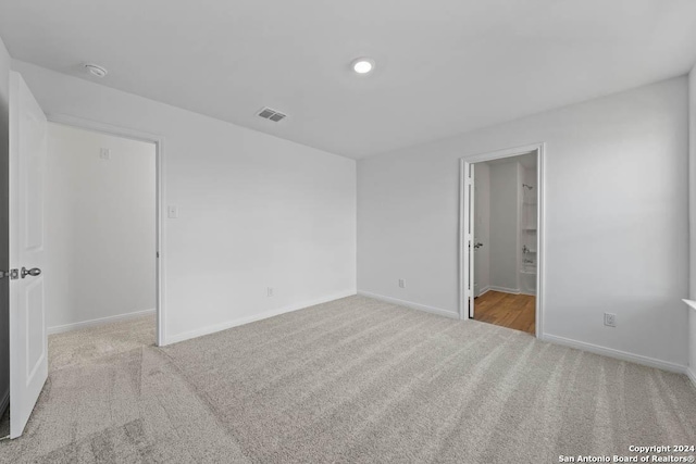 unfurnished bedroom featuring baseboards, visible vents, and carpet flooring