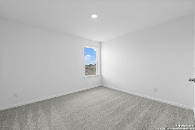 carpeted spare room with recessed lighting and baseboards