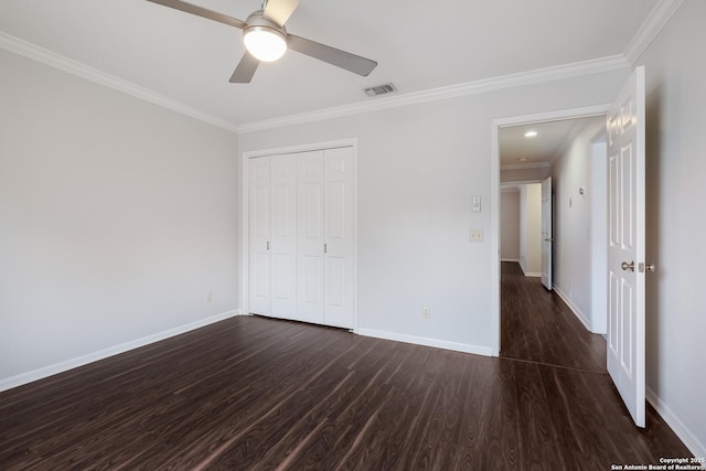 unfurnished bedroom with visible vents, ornamental molding, dark wood-style floors, and baseboards