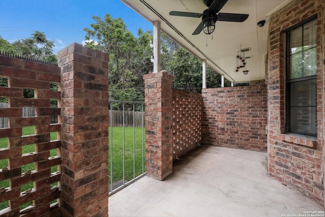 view of patio featuring fence and ceiling fan