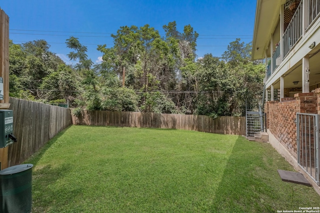 view of yard featuring a fenced backyard and central AC unit