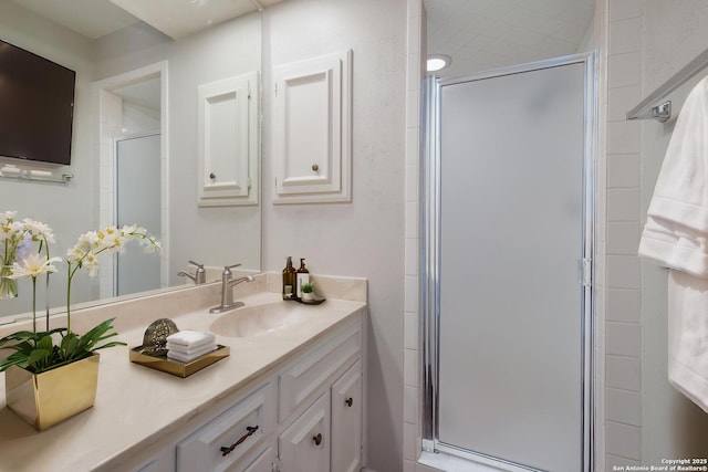 bathroom featuring vanity and a stall shower