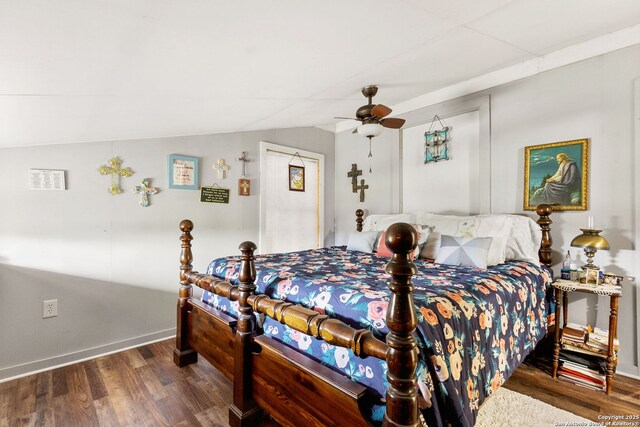 bedroom with ceiling fan, vaulted ceiling, wood finished floors, and baseboards