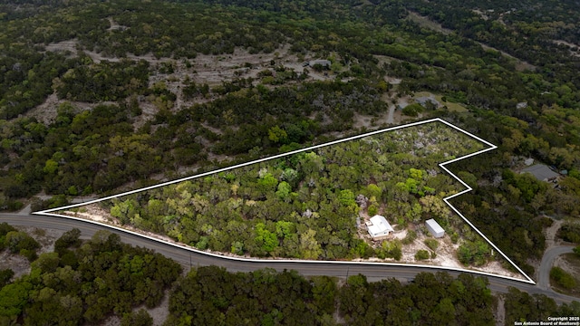 birds eye view of property with a forest view
