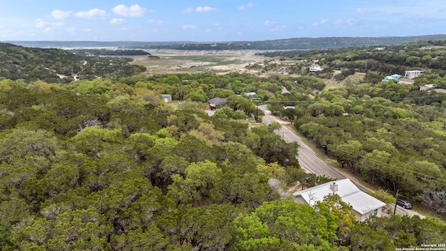 birds eye view of property featuring a wooded view