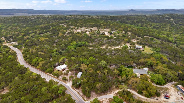 drone / aerial view featuring a view of trees