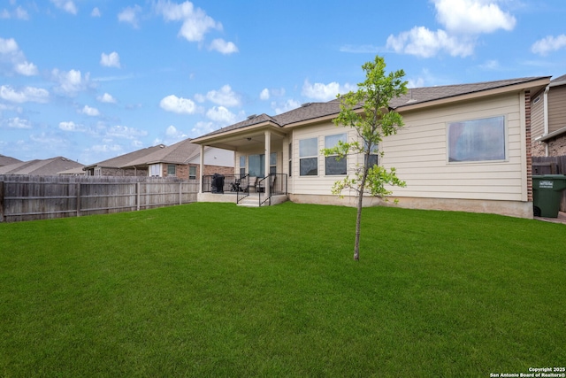 back of house with a patio, a yard, and fence private yard