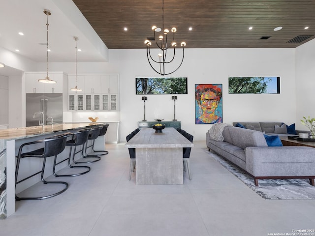 living area featuring concrete floors, visible vents, recessed lighting, and wooden ceiling