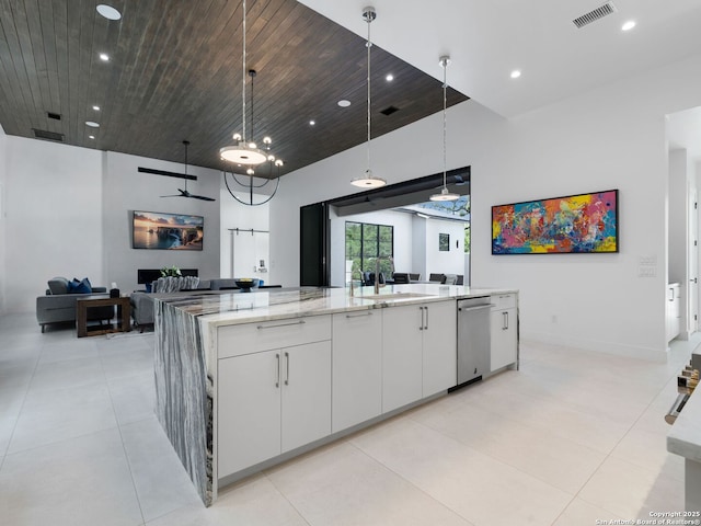 kitchen featuring recessed lighting, a sink, white cabinetry, visible vents, and open floor plan