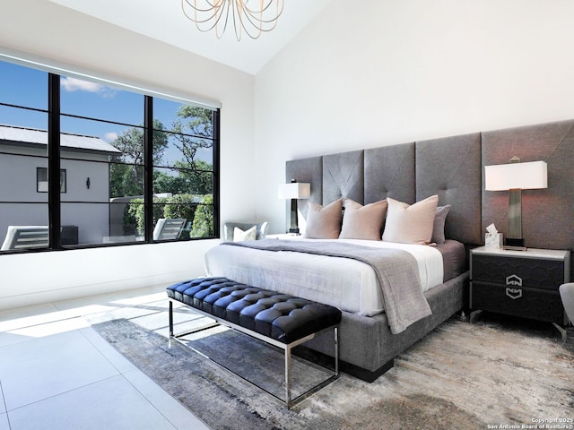 bedroom with a chandelier and vaulted ceiling
