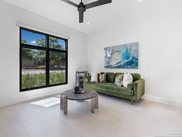 living area featuring light tile patterned floors, recessed lighting, ceiling fan, and baseboards