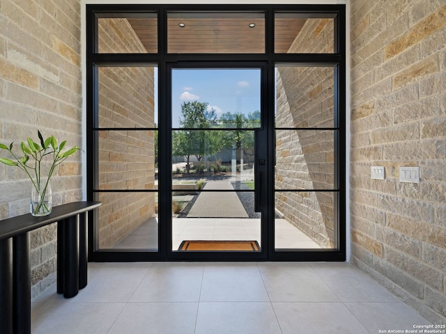 entryway featuring tile patterned floors and floor to ceiling windows