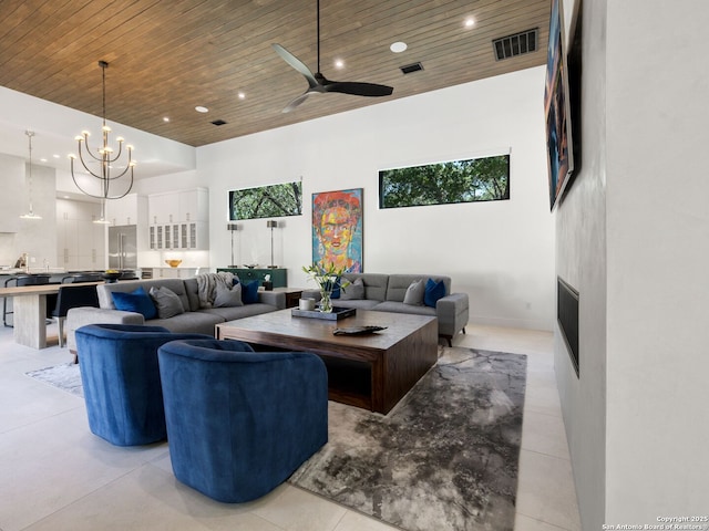 living area featuring recessed lighting, wooden ceiling, visible vents, a towering ceiling, and ceiling fan with notable chandelier