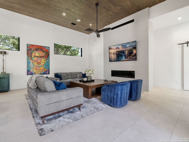 living room featuring wood ceiling, visible vents, plenty of natural light, and recessed lighting