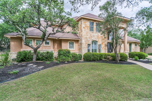 831 Fawnway, San Antonio, TX 78260 - mediterranean / spanish-style house with a shingled roof, a front lawn, stucco siding, and stone siding
