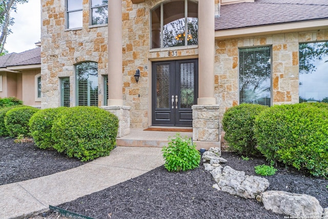 831 Fawnway, San Antonio, TX 78260 - view of exterior entry featuring french doors, roof with shingles, and stone siding