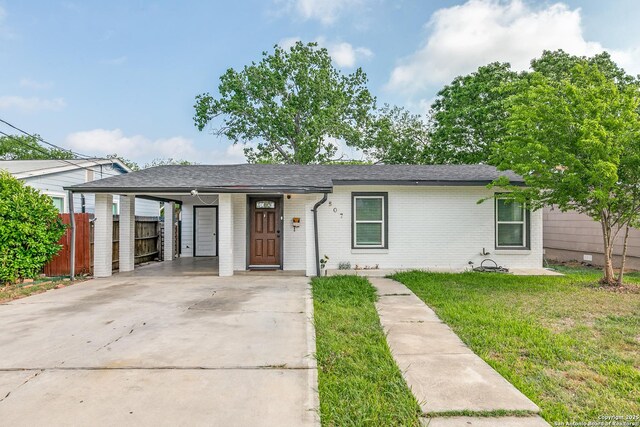 507 Lovera, San Antonio, TX 78212 - ranch-style house featuring driveway, an attached carport, a front yard, fence, and brick siding
