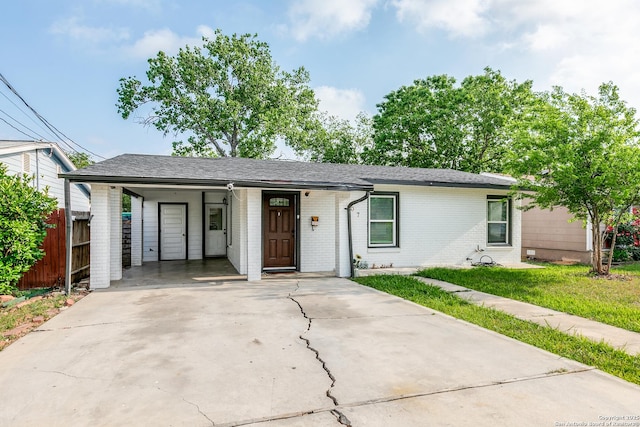 507 Lovera, San Antonio, TX 78212 - ranch-style house with driveway, fence, a carport, and brick siding