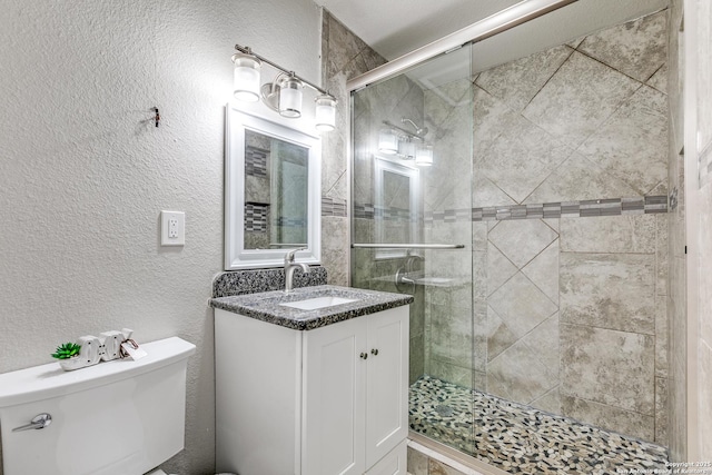 507 Lovera, San Antonio, TX 78212 - bathroom featuring a shower stall, toilet, a textured wall, and vanity