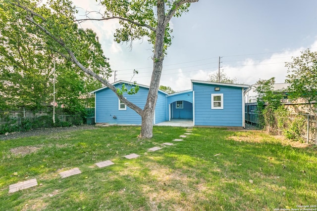 507 Lovera, San Antonio, TX 78212 - back of property featuring a carport, a yard, and a fenced backyard