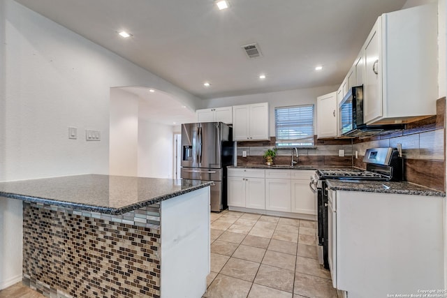 507 Lovera, San Antonio, TX 78212 - kitchen with arched walkways, visible vents, white cabinetry, and stainless steel appliances