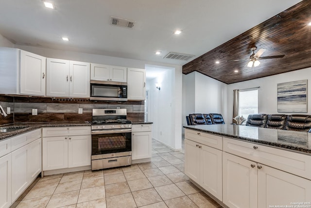 507 Lovera, San Antonio, TX 78212 - kitchen featuring dark stone countertops, visible vents, stainless steel appliances, ceiling fan, and backsplash