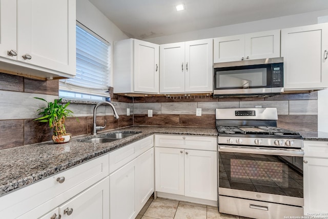 507 Lovera, San Antonio, TX 78212 - kitchen featuring dark stone counters, a sink, white cabinetry, and stainless steel appliances