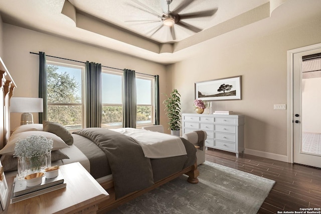 bedroom featuring baseboards, a raised ceiling, dark wood-style flooring, and multiple windows