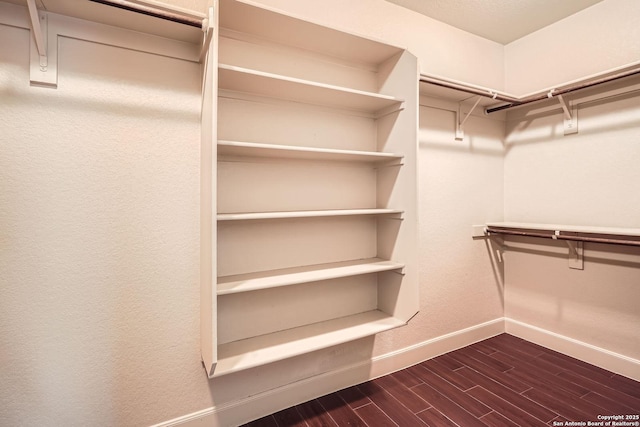 walk in closet featuring dark wood-style flooring