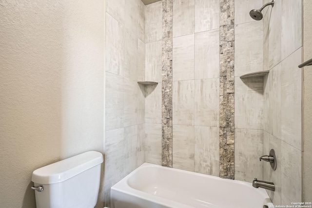 bathroom with a textured wall, toilet, and bathtub / shower combination