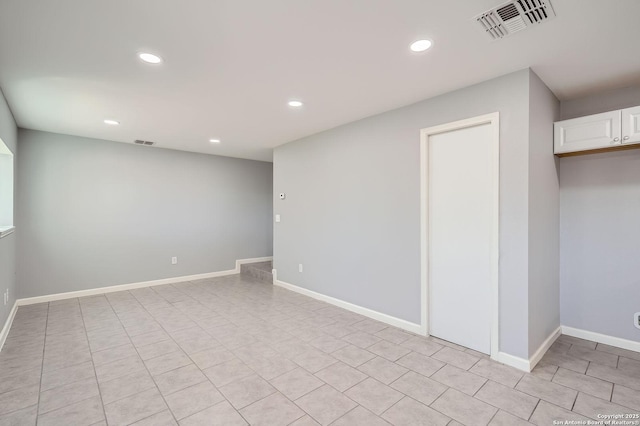 below grade area with light tile patterned floors, recessed lighting, visible vents, and baseboards