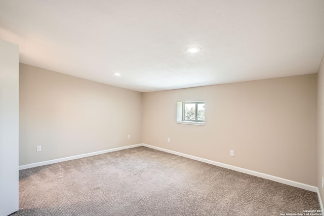 carpeted spare room featuring recessed lighting and baseboards