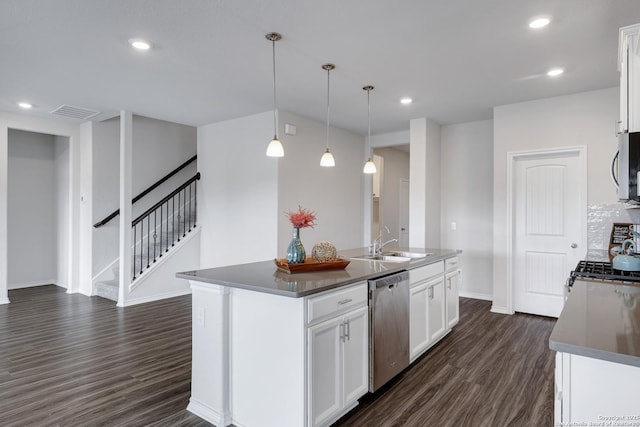 9416 Tennant Ln, Converse, TX 78109 - kitchen with stainless steel appliances, dark countertops, a sink, baseboards, and dark wood-type flooring