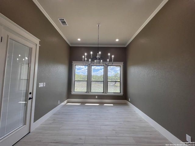 unfurnished dining area featuring light wood finished floors, an inviting chandelier, crown molding, visible vents, and baseboards