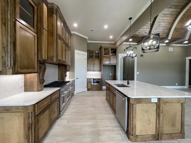 kitchen with appliances with stainless steel finishes, tasteful backsplash, crown molding, and a sink