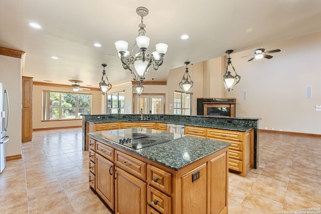 125 Creek Spgs, Boerne, TX 78006 - kitchen featuring ceiling fan with notable chandelier, appliances with stainless steel finishes, a kitchen island, and a sink
